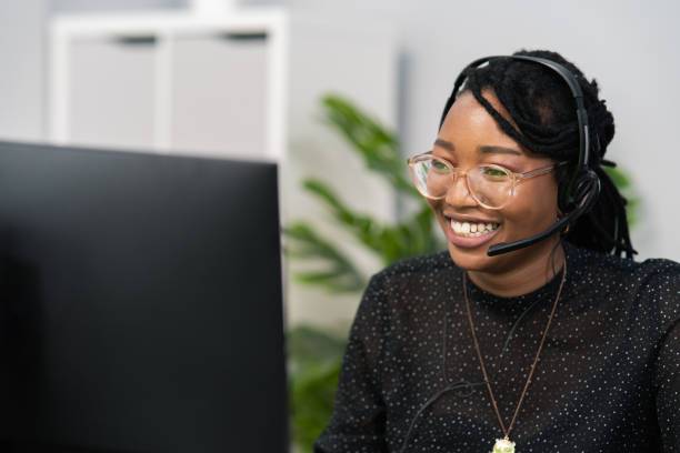 black woman receptionist speaking on phone with clients